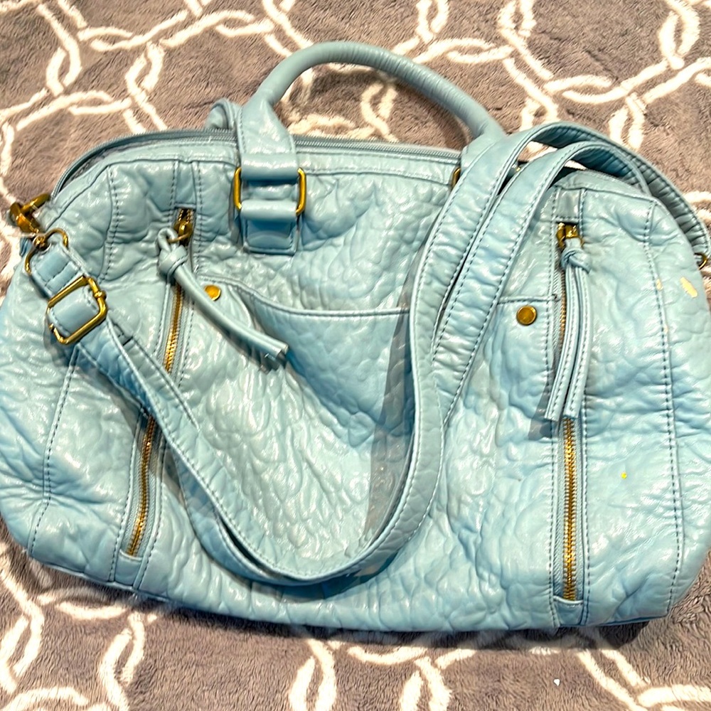 Baby blue women’s purse. Can be used as shoulder bag or hang from the arm.